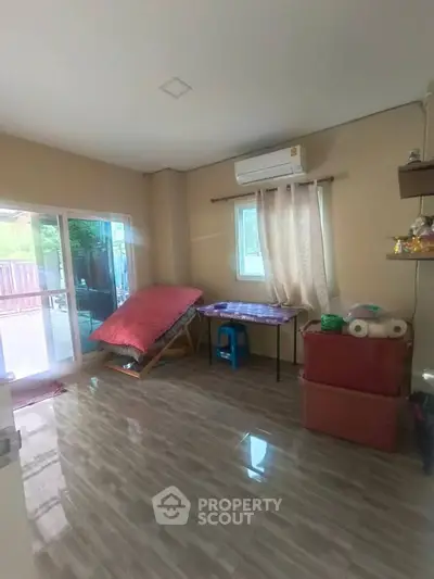 Spacious room with air conditioning and sliding glass doors leading to a patio, ideal for versatile living.