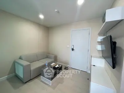 Modern living room with sleek furniture and wall-mounted TV