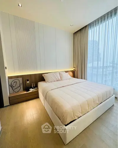 Luxurious modern bedroom with elegant decor and large window view.