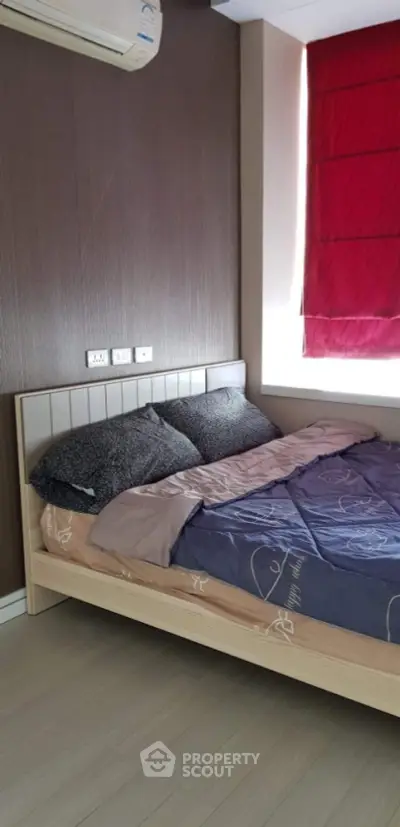 Cozy bedroom with modern decor and vibrant red curtains