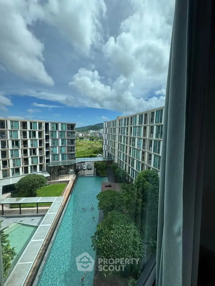 Luxurious apartment complex with stunning pool view and modern architecture.