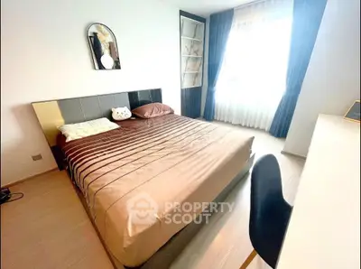 Modern bedroom with stylish decor and ample natural light