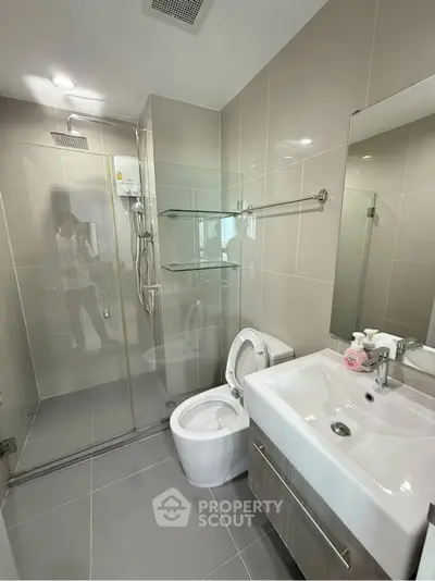 Modern bathroom with glass shower and sleek fixtures