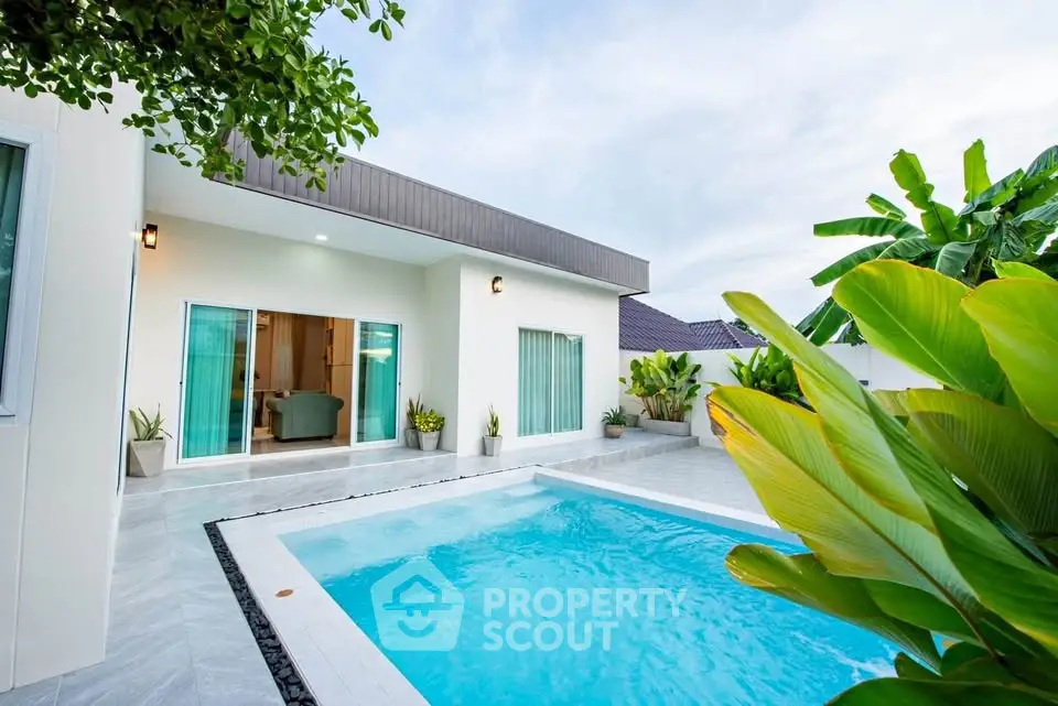 Modern villa with private pool and lush garden, perfect for luxury living.