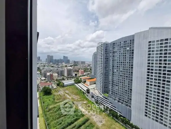 Stunning cityscape view from high-rise apartment window showcasing modern urban living.