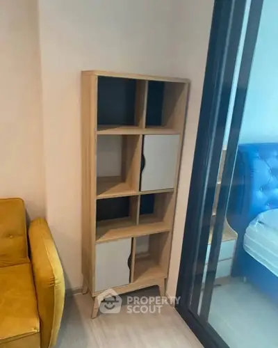 Modern apartment interior with stylish shelving and cozy furniture