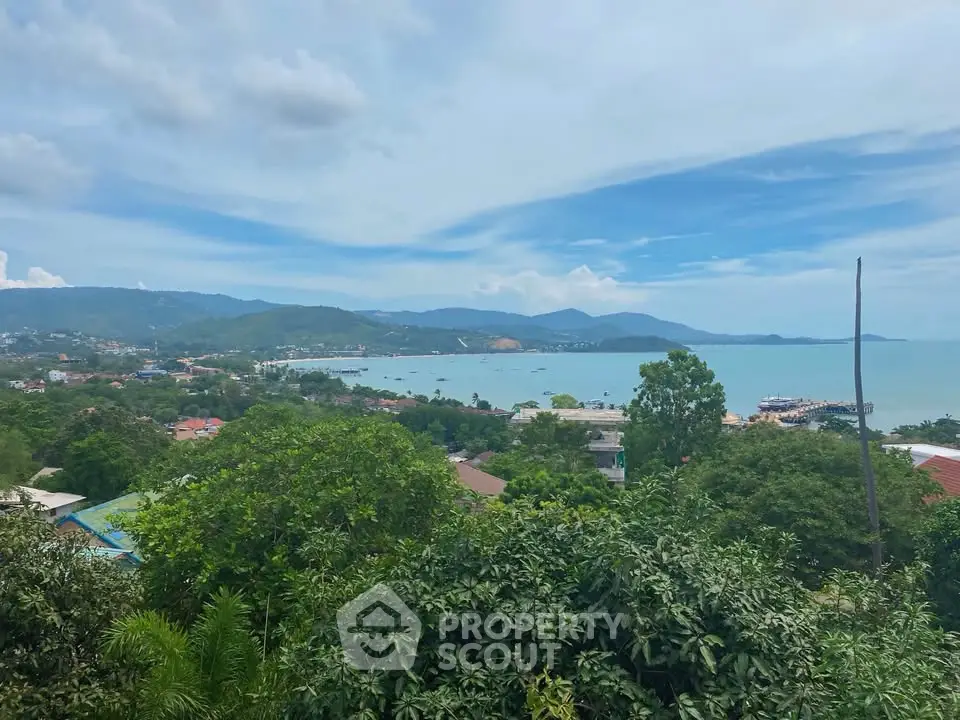 Stunning coastal view with lush greenery and serene blue waters, perfect for a tranquil living experience.