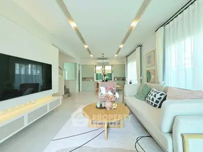 Spacious modern living room with elegant decor and large TV, perfect for relaxation and entertainment.