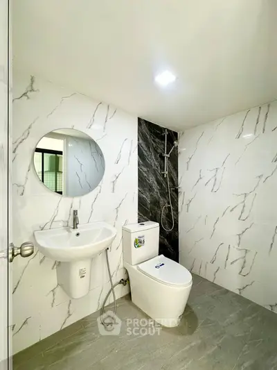 Modern bathroom with marble tiles and sleek fixtures