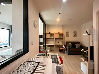 Modern open-plan living room with stylish decor and natural light