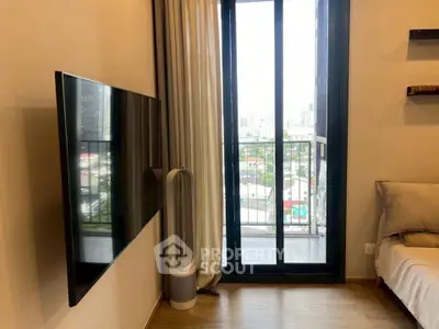 Modern living room with wall-mounted TV and balcony view in a stylish apartment.