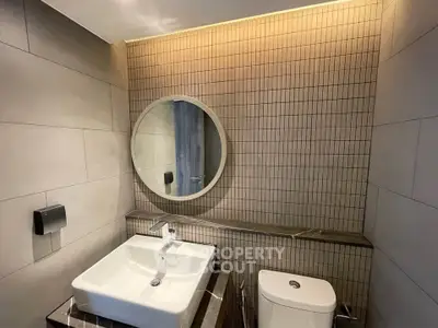 Modern bathroom with stylish round mirror and sleek sink design