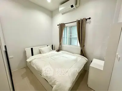 Cozy bedroom with modern furnishings and air conditioning, perfect for restful nights.