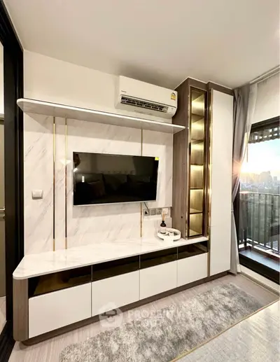 Modern living room with sleek TV unit and balcony view
