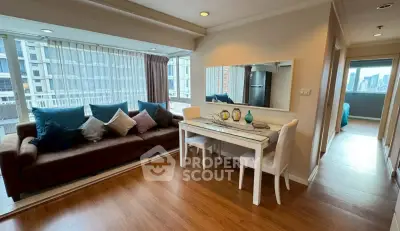Spacious living room with elegant decor and city view in modern apartment.
