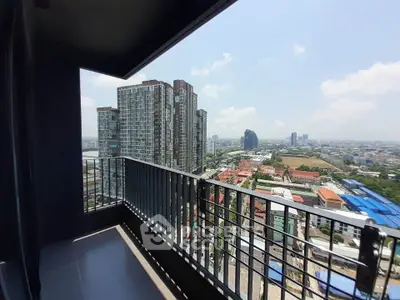Spacious balcony with stunning cityscape view in modern high-rise apartment.