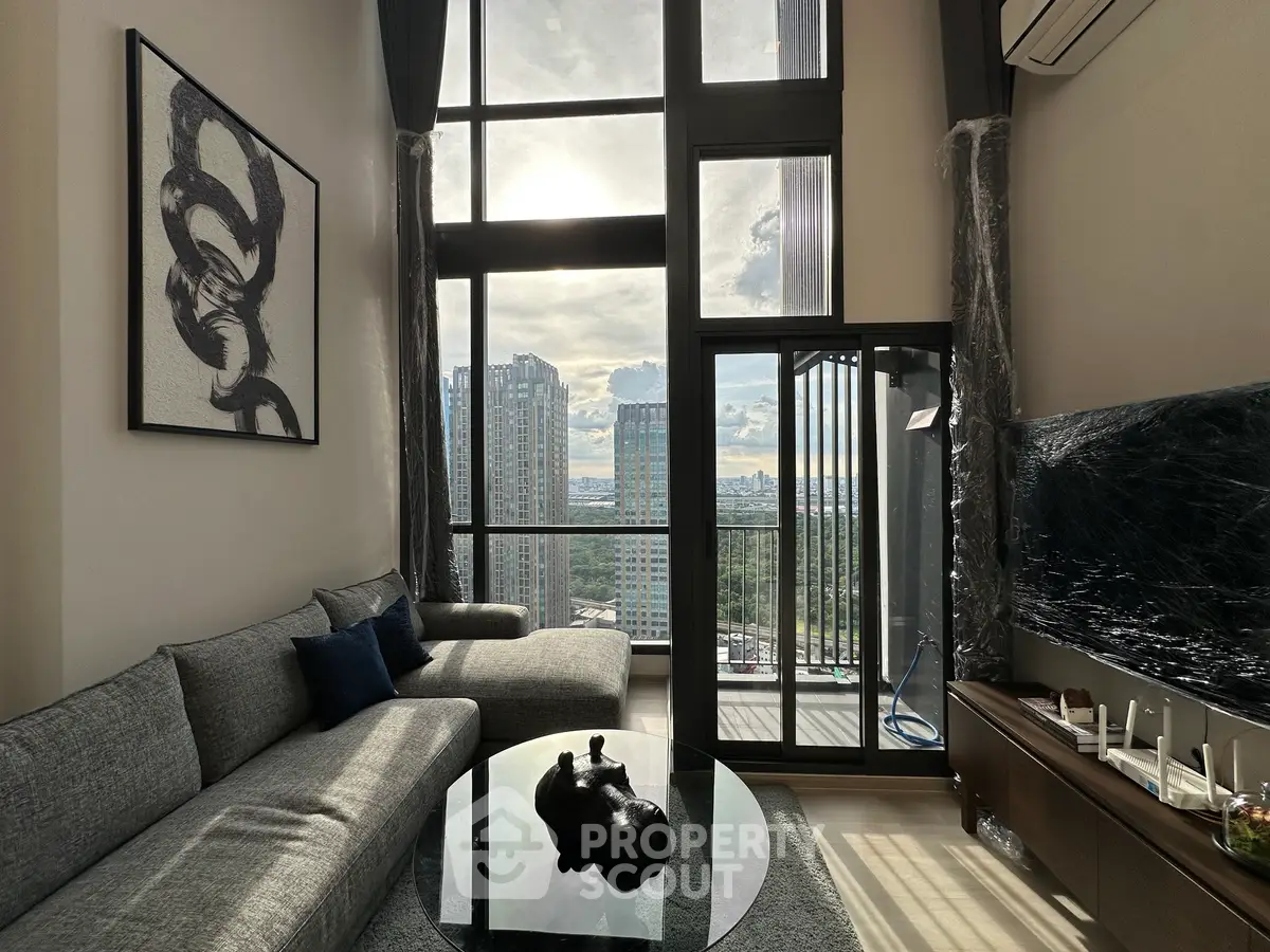 Luxurious high-rise living room with floor-to-ceiling windows and stunning city view