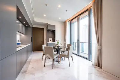 Luxurious modern kitchen with open layout and stunning city view.