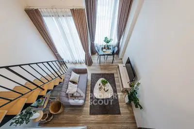 Modern loft-style living room with high ceilings and elegant decor