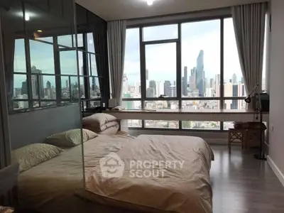 Luxurious bedroom with stunning city skyline view and modern glass partition.