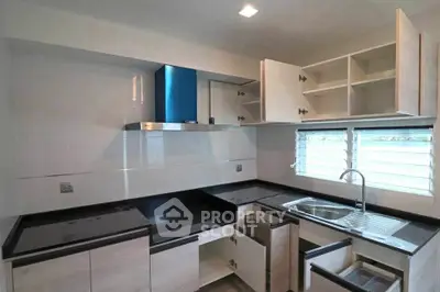 Modern kitchen with sleek cabinetry and ample storage space