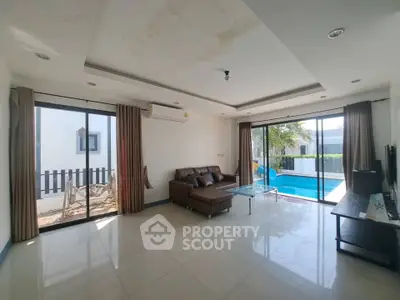 Spacious living room with pool view in modern home