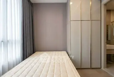 Modern minimalist bedroom with sleek wardrobe and natural light
