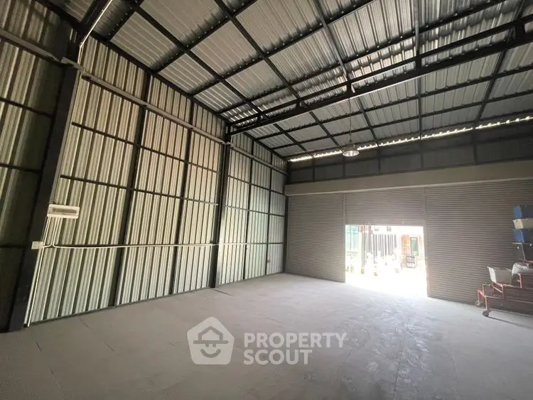 Spacious industrial warehouse with high ceilings and large roller doors