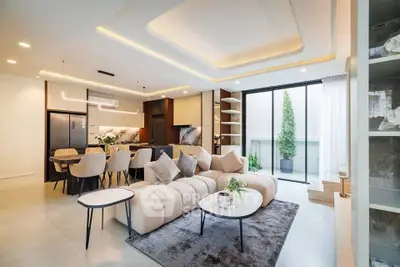 Luxurious open-plan living room with modern kitchen and elegant decor