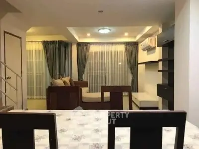 Spacious living room with modern furniture and elegant curtains, perfect for relaxation and entertainment.