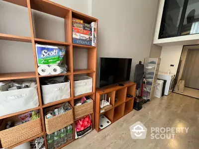 Modern living room with wooden shelving and entertainment setup