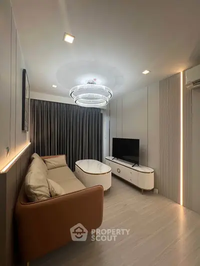 Modern living room with sleek design, featuring a cozy sofa, stylish lighting, and a flat-screen TV.