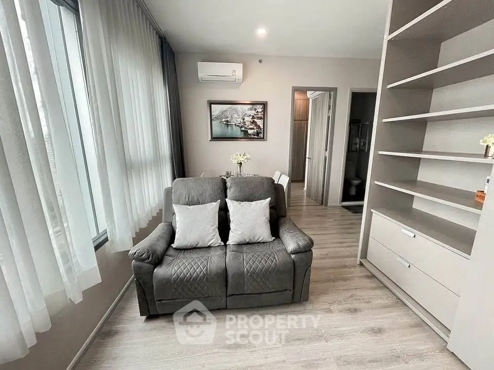 Modern living room with cozy sofa and stylish decor in a bright apartment.