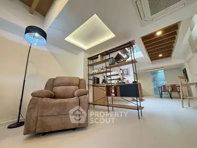 Modern living room with cozy armchair and stylish shelving unit