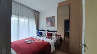 Cozy bedroom with large window and stylish decor