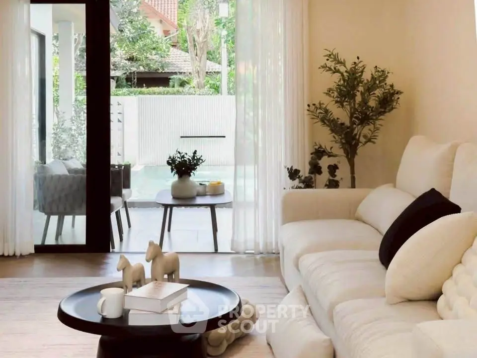 Elegant living room with plush sofa and garden view, perfect for relaxation and entertaining.