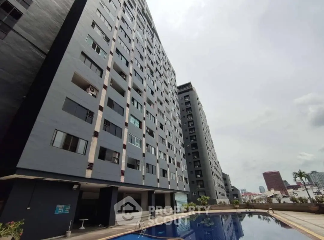 Modern high-rise building with pool and city view