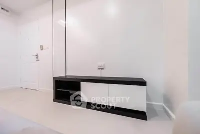 Minimalist interior with sleek black and white TV stand in modern living room.