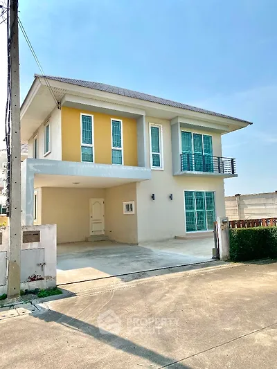 Modern two-story house with spacious driveway and large windows