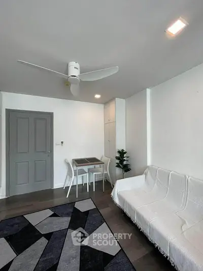 Modern living room with stylish decor and ceiling fan