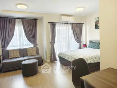Spacious studio apartment with modern furnishings and natural light.