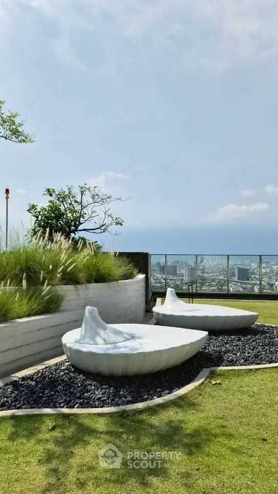 Stunning rooftop garden with modern seating and panoramic city views.