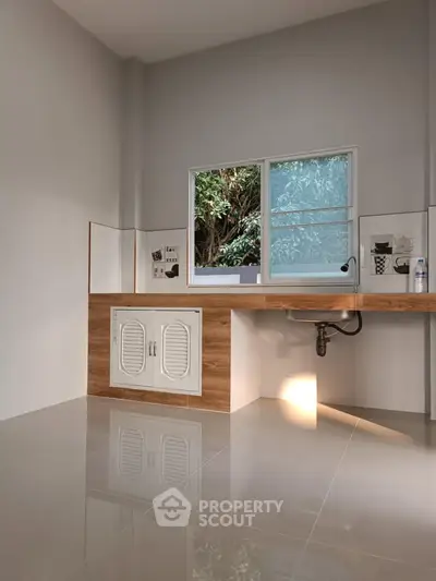 Modern kitchen with sleek design and large window view