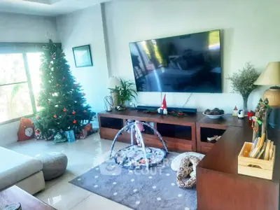 Spacious living room with Christmas decor and modern entertainment setup.