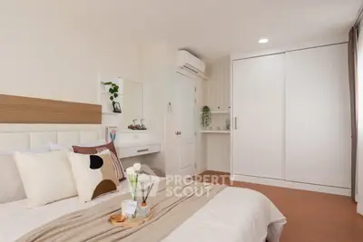 Modern bedroom with stylish decor and ample natural light