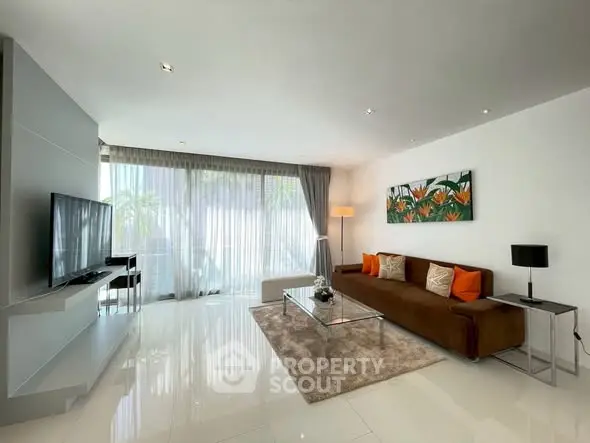 Modern living room with sleek design, large windows, and stylish decor.