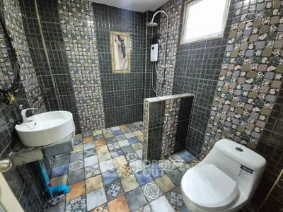 Charming bathroom with unique tile design and modern fixtures, perfect for a stylish home upgrade.