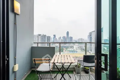 Charming balcony with city skyline view, perfect for relaxing and enjoying urban living.