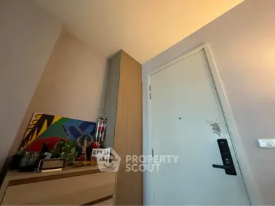 Modern apartment entrance with stylish decor and secure door lock.