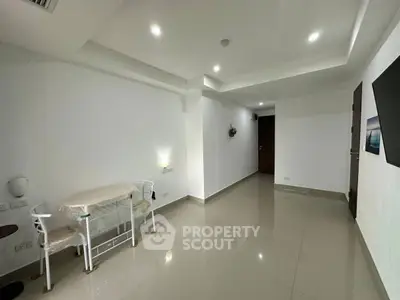 Spacious minimalist interior with glossy tiled floors and modern lighting